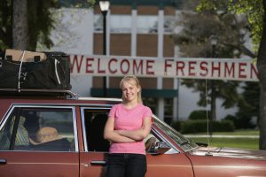 fresh student in front on her car